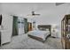 Bright bedroom featuring a ceiling fan, a large window, and neutral-toned walls, offering a serene and inviting atmosphere at 8055 Tank Loop St, Las Vegas, NV 89166