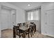 Dining area features a wooden table, six chairs and natural light from window with modern window covering at 8055 Tank Loop St, Las Vegas, NV 89166