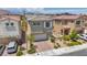 Beautiful two-story home featuring a brick-paved driveway, attached garage, and lovely landscaping at 8055 Tank Loop St, Las Vegas, NV 89166