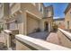 View of the home's covered porch with outdoor seating and a wrought iron fence at 8055 Tank Loop St, Las Vegas, NV 89166