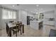 Bright kitchen and dining area features white cabinets, stainless steel appliances, and wood dining table at 8055 Tank Loop St, Las Vegas, NV 89166