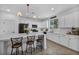 Bright kitchen features white cabinets, stainless steel appliances, and a large center island with bar seating at 8055 Tank Loop St, Las Vegas, NV 89166