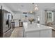 Modern kitchen featuring white cabinets, stainless steel appliances, and a large center island at 8055 Tank Loop St, Las Vegas, NV 89166