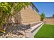 Landscaped backyard with decorative rocks, retaining wall, and artificial turf, offering low maintenance at 8055 Tank Loop St, Las Vegas, NV 89166