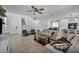 Open concept living room with tile flooring, ceiling fan, and neutral color palette at 8055 Tank Loop St, Las Vegas, NV 89166