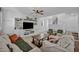 Spacious living room featuring built-in shelving, neutral decor, and access to the staircase at 8055 Tank Loop St, Las Vegas, NV 89166