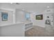 Neutral loft area features carpet, storage shelves, and abundant natural light at 8055 Tank Loop St, Las Vegas, NV 89166