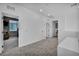 Open loft area features neutral walls, carpet, and entry to one bedroom at 8055 Tank Loop St, Las Vegas, NV 89166