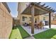 Outdoor living with a covered patio, putting green, and seating area, ideal for entertaining at 8055 Tank Loop St, Las Vegas, NV 89166