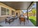 Covered patio featuring stylish outdoor seating and a dining area overlooking the landscaped backyard at 8055 Tank Loop St, Las Vegas, NV 89166