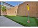 Backyard putting green with artificial turf, flags, and a well-maintained landscape at 8055 Tank Loop St, Las Vegas, NV 89166