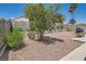 Low-maintenance backyard featuring a barbecue and a variety of desert plants and greenery at 8242 Tribute Ln, Las Vegas, NV 89147