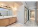Bathroom featuring dual sinks, tile flooring, large mirror, and access to the bedroom at 8242 Tribute Ln, Las Vegas, NV 89147