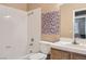 Standard bathroom featuring a shower-tub combo, tiled walls, and vanity with granite-style counters at 8242 Tribute Ln, Las Vegas, NV 89147
