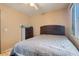 Cozy bedroom featuring a neutral color palette, a large bed, and a ceiling fan at 8242 Tribute Ln, Las Vegas, NV 89147