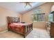 Neutral bedroom with a large bed, ceiling fan, and a view of the neighborhood at 8242 Tribute Ln, Las Vegas, NV 89147
