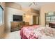 Neutral bedroom with a large bed, dresser and view of en suite bathroom at 8242 Tribute Ln, Las Vegas, NV 89147