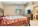 Neutral bedroom with a large bed, and view of the en suite bathroom at 8242 Tribute Ln, Las Vegas, NV 89147