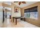 Casual dining area with tile floors and a view into the kitchen and backyard, next to the living room at 8242 Tribute Ln, Las Vegas, NV 89147