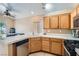 Functional kitchen featuring tile countertops, wooden cabinets, and a full suite of appliances at 8242 Tribute Ln, Las Vegas, NV 89147
