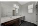 This bathroom features a double sink vanity with black tile floors at 8754 Moon Crater Ave, Las Vegas, NV 89178