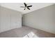 This bedroom features a ceiling fan, two doors, and neutral-toned walls at 8754 Moon Crater Ave, Las Vegas, NV 89178