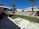 Spacious backyard with a well-maintained lawn, mature palm trees, and privacy wall at 9036 Cotton Rose Way, Las Vegas, NV 89134