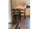Kitchen with white cabinets, dining table and black chairs, and dark floors at 9036 Cotton Rose Way, Las Vegas, NV 89134