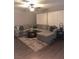 Spacious living room featuring a plush sectional sofa, stylish rug, and modern decor at 9036 Cotton Rose Way, Las Vegas, NV 89134