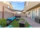 Spacious backyard with a patio, artificial grass, outdoor seating, grill and a hot tub at 9208 S Park St, Las Vegas, NV 89178