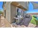 Grilling area with pavers, artificial grass, and sun shade, perfect for entertaining in this comfortable backyard at 9208 S Park St, Las Vegas, NV 89178