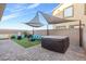 Relaxing backyard with patio, artificial grass, comfortable seating, and a soothing hot tub at 9208 S Park St, Las Vegas, NV 89178