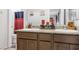 Bathroom with dual sinks, granite counters, and rich wood cabinets providing ample storage space at 9208 S Park St, Las Vegas, NV 89178