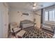 Cozy Bedroom with crib, ceiling fan, glider chair, and window with treatments at 9208 S Park St, Las Vegas, NV 89178