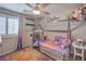 Bright bedroom with a bed, ceiling fan, artwork, and window with treatments at 9208 S Park St, Las Vegas, NV 89178