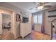 Bright bedroom with a dresser, ceiling fan, window with treatments, and play area at 9208 S Park St, Las Vegas, NV 89178