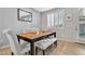 Bright dining area features stylish seating, neutral paint, and a modern mirror to complement the space at 9208 S Park St, Las Vegas, NV 89178