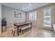 Bright dining area features stylish seating, neutral paint, and a modern mirror to complement the space at 9208 S Park St, Las Vegas, NV 89178