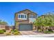 Inviting two-story home featuring a well-manicured front yard and charming architectural details at 9208 S Park St, Las Vegas, NV 89178