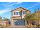 Charming two-story home featuring a two-car garage and well-maintained landscaping, set against a bright blue sky at 9208 S Park St, Las Vegas, NV 89178