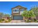 Inviting two-story home featuring a well-manicured front yard and charming architectural details at 9208 S Park St, Las Vegas, NV 89178