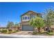 Inviting two-story home featuring a well-manicured front yard and charming architectural details at 9208 S Park St, Las Vegas, NV 89178