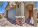 Home exterior showing the stone-accented garage with a brick-paved driveway and entryway at 9208 S Park St, Las Vegas, NV 89178