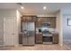 Modern kitchen with stainless steel appliances, granite countertops, and tile flooring at 9208 S Park St, Las Vegas, NV 89178