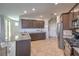 Modern kitchen with stainless steel appliances, granite countertops, and tile flooring at 9208 S Park St, Las Vegas, NV 89178