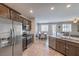 Open kitchen with stainless steel appliances flows into a bright living space with shuttered windows at 9208 S Park St, Las Vegas, NV 89178