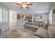 Bright living space with a large sectional sofa, open kitchen access, and modern finishes at 9208 S Park St, Las Vegas, NV 89178
