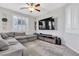 Comfortable living room featuring a large gray sectional sofa and stylish entertainment center at 9208 S Park St, Las Vegas, NV 89178