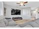 Comfortable living area with a large sectional sofa, TV, neutral walls, and shuttered windows for natural light at 9208 S Park St, Las Vegas, NV 89178