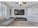 Cozy living room features a large television, neutral walls, and shuttered windows for ample natural light at 9208 S Park St, Las Vegas, NV 89178